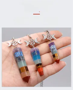 Macro view of seven chakra natural crystal hexagonal pendants with silver moon and star detail