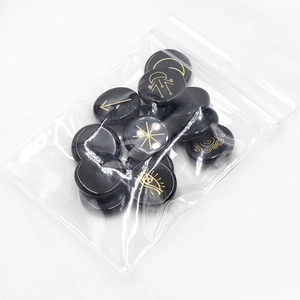 Set of natural black agate witch runes with gold engraved symbols for divination