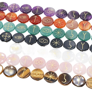 Polished natural crystal runes stones with engraved gold witch symbols and healing gemstones