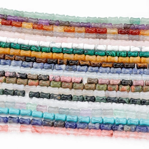 Macro shot of assorted gemstone bamboo joint beads in vibrant colors for DIY jewelry making