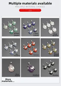 Macro display of nine natural crystal butterfly teardrop pendants in various gemstones