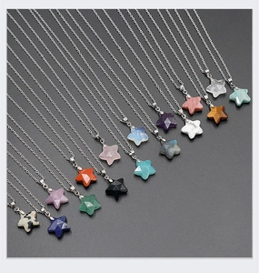 Macro shot of faceted star-shaped natural stone pendants in various colors with silver chains