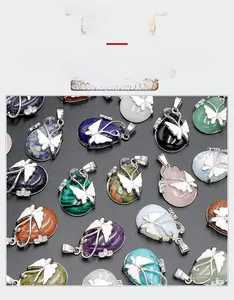 Macro shot of assorted teardrop crystal pendants featuring butterfly metal overlays