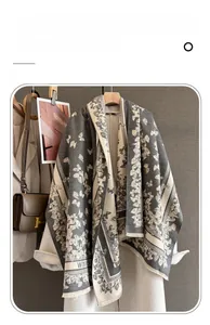 Detail of soft thick imitation cashmere scarf with butterfly jacquard and fringe