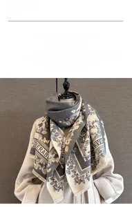 Detail of soft cashmere-like butterfly pattern scarf in grey and beige tones