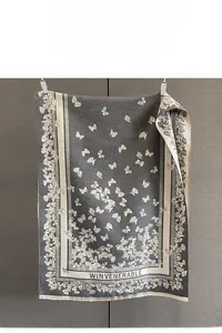 Macro detail of French vintage butterfly jacquard scarf with soft fringe and fine texture