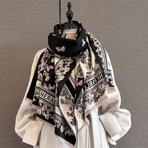 Detail of butterfly jacquard pattern and soft fringe on black and white pashmina shawl