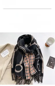 Flat lay of cashmere-feel scarf with geometric circles and houndstooth fringe detail