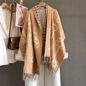Close-up of double-sided cashmere-like scarf with vintage key pattern and long tassels
