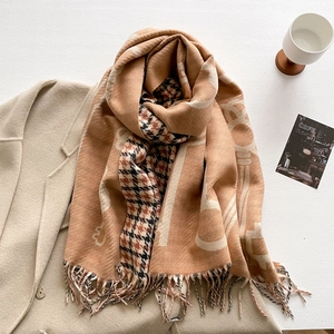 Detail of camel cashmere-like scarf showing houndstooth pattern and handmade tassels