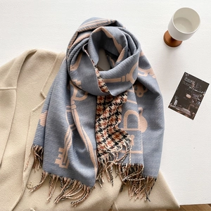 Detailed shot of cashmere-like scarf with blue pink letter print and houndstooth pattern