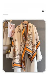 Detail of vintage imitation cashmere shawl with butterfly pattern over a white coat