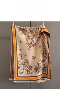 Detailed butterfly jacquard patterns and elegant fringe on a beige pashmina scarf