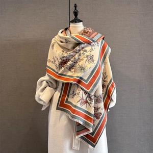 Detail of cream cashmere-feel shawl with vintage butterfly floral print and tassels