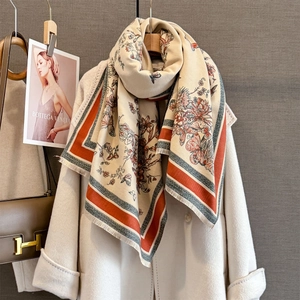 Detail of autumn cashmere-feel shawl with butterfly jacquard and delicate fringe trim