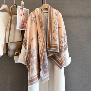 Detail of cashmere-like shawl with butterfly jacquard, floral patterns and fringed edges