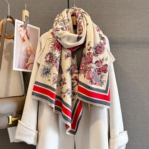 Close-up of beige pashmina shawl featuring floral butterfly patterns and fringe details