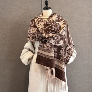 Close-up of thick winter scarf showing vintage jacquard patterns and tassel fringe details