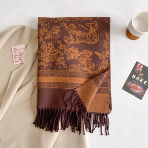 Detail of cashmere-like shawl with vintage jacquard pattern and soft thick tassels