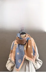 Detail view of winter imitation cashmere scarf featuring floral patterns and soft fringe