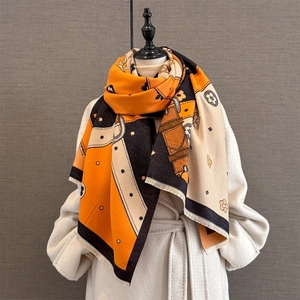 Thick jacquard scarf in orange and black with geometric floral patterns and fringe