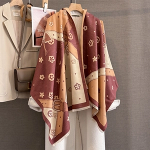 Thick jacquard winter scarf with floral and geometric patterns on a white wool coat