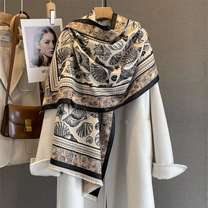 Elegant cashmere-feel pashmina shawl featuring cream seashell prints and fringed edges