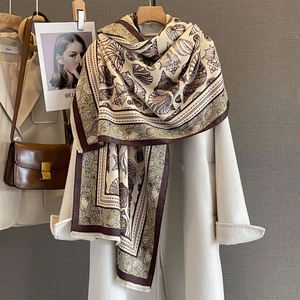 Retro seashell cashmere-feel scarf in beige and brown, styled with a wool coat
