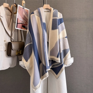 Detailed close-up of geometric color-block scarf with soft fringes and cashmere texture