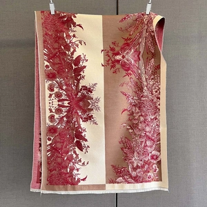Close-up of vintage floral print scarf with warm cashmere texture and fine fringe edge
