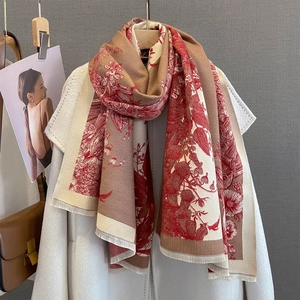 Detail of floral jacquard cashmere feel scarf with fringe on white wool coat
