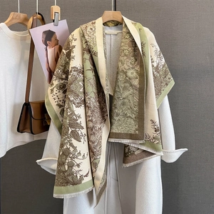 Vintage dual-tone floral pashmina scarf in olive and beige styled on a white coat