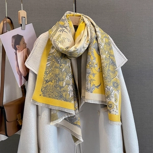Vintage floral cashmere-feel scarf in yellow and grey with fringe on a white coat