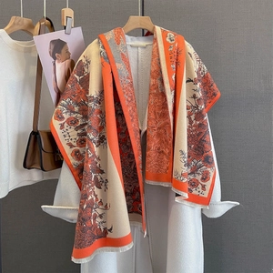 Detail of vintage floral scarf with orange and beige color block and fringe edges