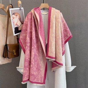 Detail of pink and beige cashmere-feel jacquard shawl with tassel edges and scroll patterns