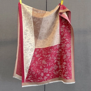 Detail view of burgundy paisley printed shawl with elegant fringe and floral patterns