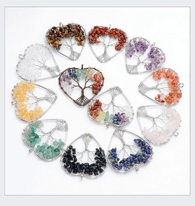 Detailed set of twelve handmade heart-shaped tree of life pendants with natural crystal stones