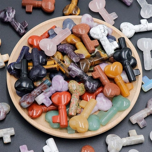 Macro shot of assorted natural crystal heart-shaped key carvings on a wooden tray