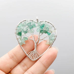 Handmade heart-shaped Tree of Life pendant with silver wire wrapping and green crystals