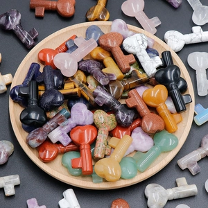 Polished natural crystal heart key pendants on wood tray featuring various gemstones
