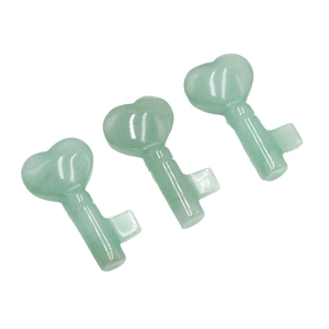 Three green aventurine heart-shaped key carvings neatly arranged on a white background