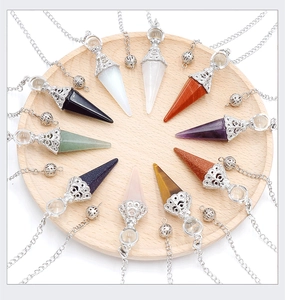 Detailed top view of ten hexagonal crystal pendulum pendants in various natural stones