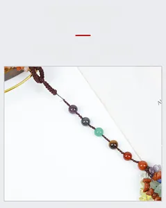 Macro detail of multicolored natural crystal stone beads and braided hanging ornament