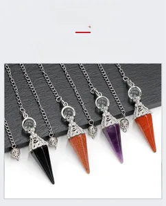 Macro view of natural crystal hexagonal pendulums with vintage silver filigree caps