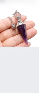 Detailed view of amethyst hexagonal prism pendant with vintage silver engraved cap
