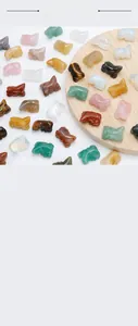 Close-up of mixed natural crystal stones carved in small animal shapes for kids