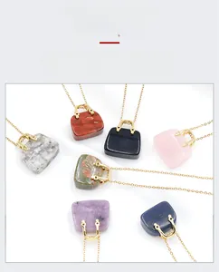 Detailed macro view of seven mini natural crystal handbag pendants with gold metal handles