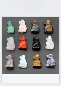 Grid display of 12 puppy figurines carved from various natural crystals and gemstones