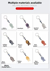 Detail showcasing nine varieties of fish-shaped natural stone Hamsa Hand keychains