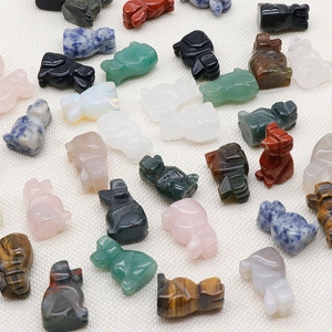Collection of carved crystal puppy figurines in various natural stones and colors